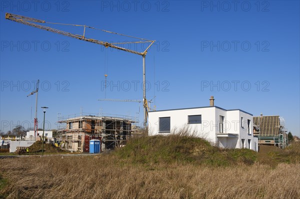 Residential building with scaffolding, construction site in a new housing estate, Kamen, North Rhine-Westphalia, Germany, Europe