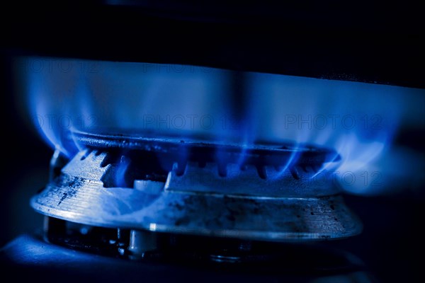 Symbolic photo on the subject of rising costs for gas. Flames in a gas cooker. Berlin, Berlin, Germany, Europe