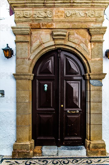 Old wooden doors with pebble mosaics on the floor, winding streets with white houses, Lindos, Rhodes, Greece, Europe