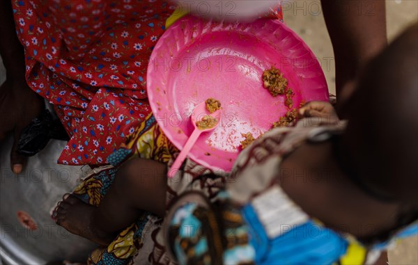 Woman is rice from a plastic bowl in Ghana, Accra, 21.02.2023., Accra, Ghana, Africa