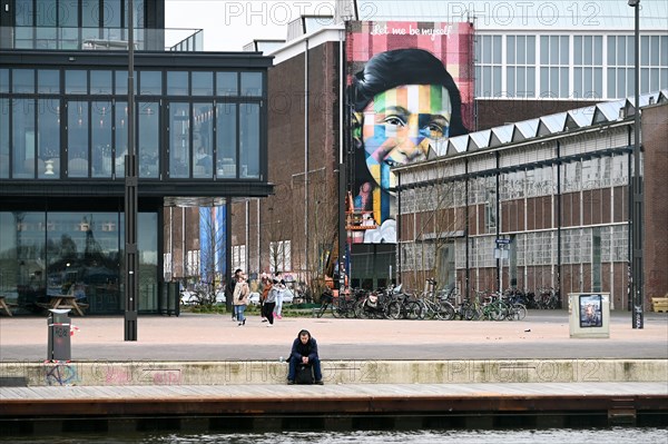 Anne Frank portrait on the facade of the Straat Museum, NDSM Plein, Amsterdam, Netherlands