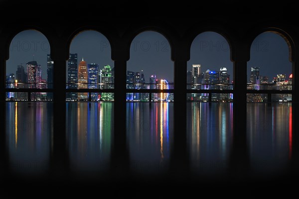 View of the illuminated skyline of Doha, Qatar, from the terrace of the Museum of Islamic Art by the archtics Ieoh Ming Pei and Jean-Michel Wilmotte, Asia