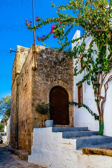 Captains house in the winding streets with white houses, Lindos, Rhodes, Greece, Europe