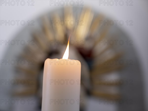 Burning candle in front of a Pieta in the Catholic parish church of St. Peter and Paul, former collegiate church, Romanesque columned basilica, Unesco World Heritage Site, Niederzell on the island of Reichenau in Lake Constance, Constance district, Baden-Wuerttemberg, Germany, Europe