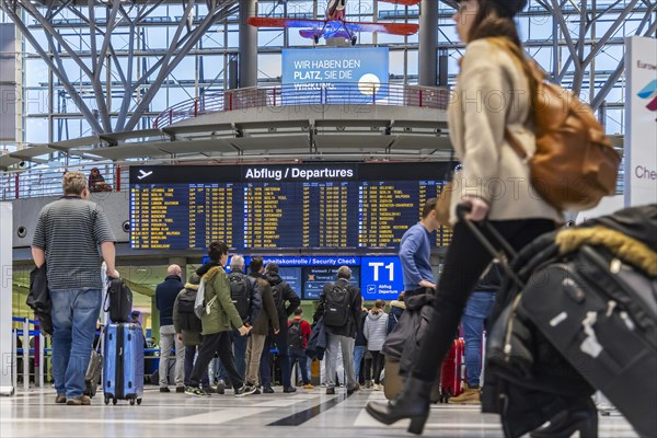 Airport terminal with departure indicator board, departure, travellers with suitcases, interior shot, Airport Echterdingen, Stuttgart, Baden-Wuerttemberg, Germany, Europe