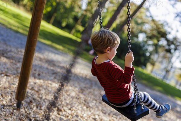 Child on a swing. Bonn, Germany, Europe