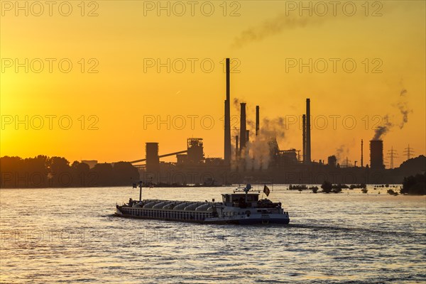 Thyssenkrupp Steel Europe AG on the Rhine, inland navigation, freighter, morning light, sunrise, Duisburg, North Rhine-Westphalia, Germany, Europe