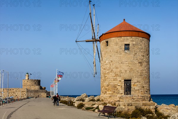 Three windmills on the pier with Agios Nikolaos fortress, Mandraki harbour, Rhodes Town, Greece, Europe