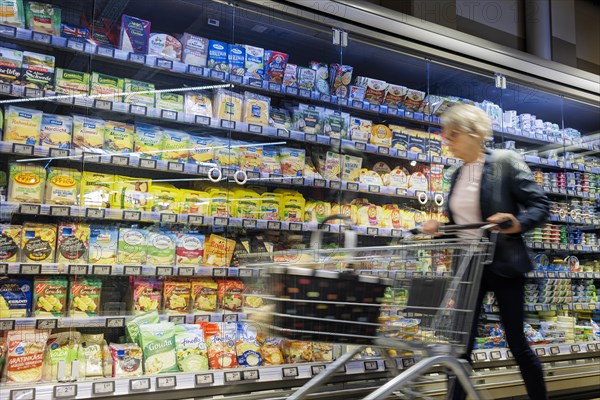 Elderly woman shopping in supermarket, Radevormwald, Germany, Europe