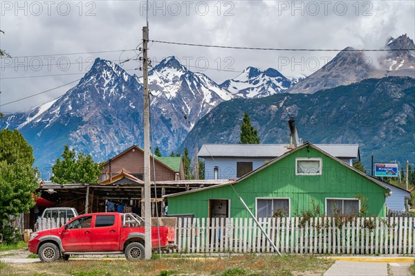 Colourful wooden houses, Cerro Castillo mountain range in the back, Villa Cerro Castillo village, Cerro Castillo National Park, Aysen, Patagonia, Chile, South America