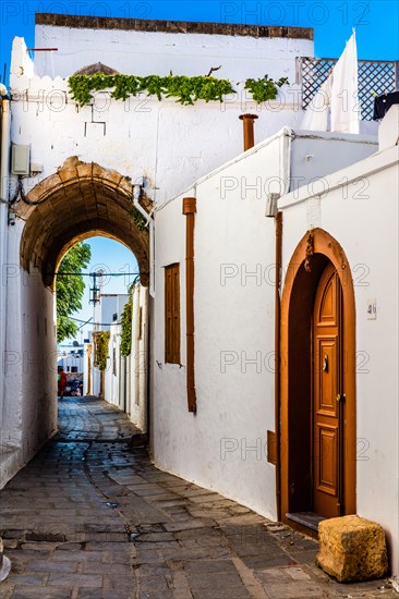 Captains house in the winding streets with white houses, Lindos, Rhodes, Greece, Europe