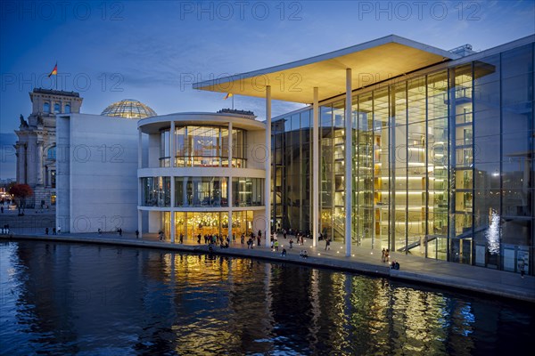 People dance in the evening next to the river Spree at Paul-Loebe-Haus in the government district. Berlin, Berlin, Germany, Europe