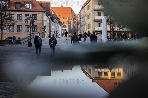 Nurembergs old town reflected in the Schuesselesbrunnen fountain at sunset. Nuremberg, 13.02.2023., Nuremberg, Germany, Europe