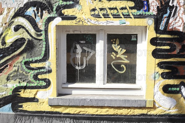 Window with colourful graffiti mural on a house wall, Bremen, Germany, Europe