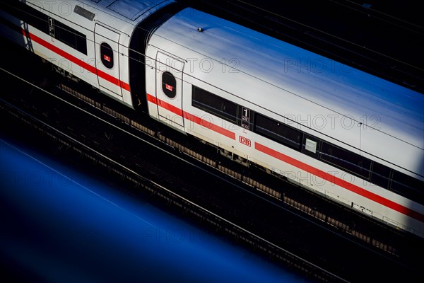 A Deutsche Bahn ICE train travels along the city railway in Berlin and is illuminated by the evening sun. Berlin, Berlin, Germany, Europe