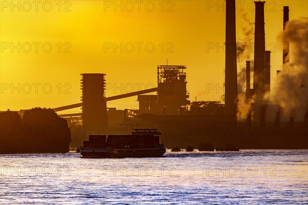 Thyssenkrupp Steel Europe AG on the Rhine, inland navigation, freighter, morning light, sunrise, Duisburg, North Rhine-Westphalia, Germany, Europe