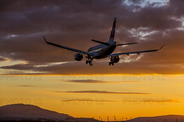 ZRH Airport with aircraft on approach of the airline Swiss, Bombardier BD-500, sunset, Zurich, Switzerland, Europe