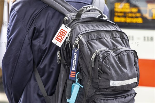 Locomotive driver with backpack and distinctive sign of the locomotive drivers of the Deutsche Bahn, main station, Stuttgart, Baden-Wuerttemberg, Germany, Europe