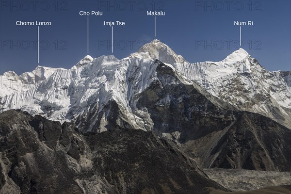 View from Chukhung Ri, a trekking peak located in the upper part of the Imja Khola valley. Imja Tse, known as Island Peak, the popular 6000-metres-plus peak, is just ahead. Makalu, the worlds sixth-highest mountain, is the highest mountain in this view and indeed looks the highest in this picture. Autumn trekking season. Khumbu, the Everest Region, Himalayas. Photo with peak labels. Sagarmatha National Park, a UNESCO World Heritage Site. Solukhumbu, Nepal, Asia