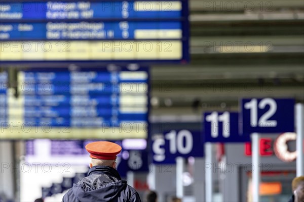 Main station with platforms and departure board, Deutsche Bahn service staff in uniform, Stuttgart, Baden-Wuerttemberg, Germany, Europe