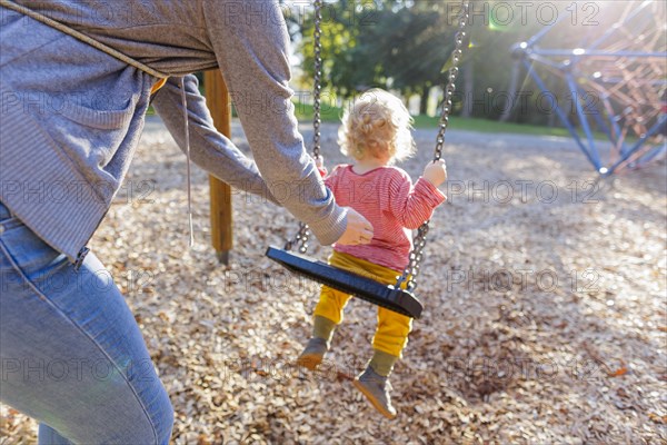 Child on a swing. Bonn, Germany, Europe