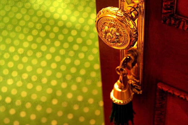 Golden door knob with key in lock