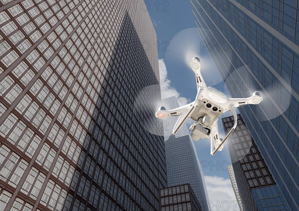 Unmanned aircraft system quadcopter drone in the air among the city and corporate buildings