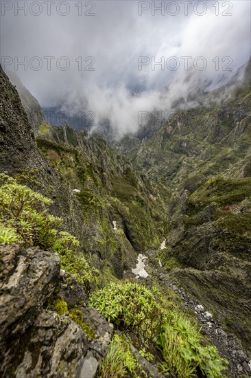 Steep cloudy mountain landscape with rock formations