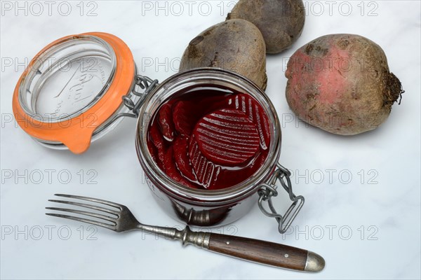 Pickled beetroot in glass jar and beetroot