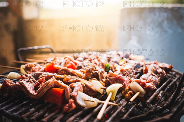Charcoal roasted meat skewers. Homemade roast meat skewers on charcoal grill. Top view of meat roasted on a grill