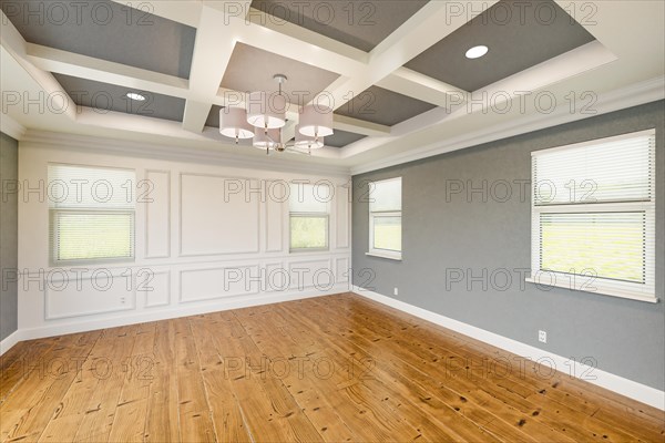 Beautiful gray custom master bedroom complete with entire wainscoting wall