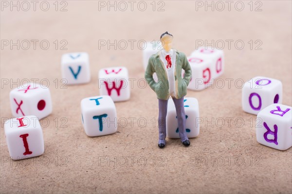 Figurine standing in front of the colorful alphabet letter cubes