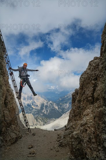 The tutor stands on a rake with a beautiful view in the background of the Alpine Dolomites. Dolomites