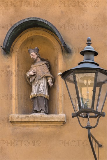 Sculpture of St. Nepomuk in a niche on a residential house