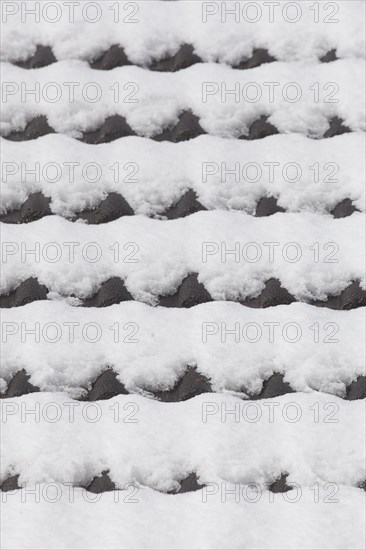 Snowy roof tiles on a roof in winter
