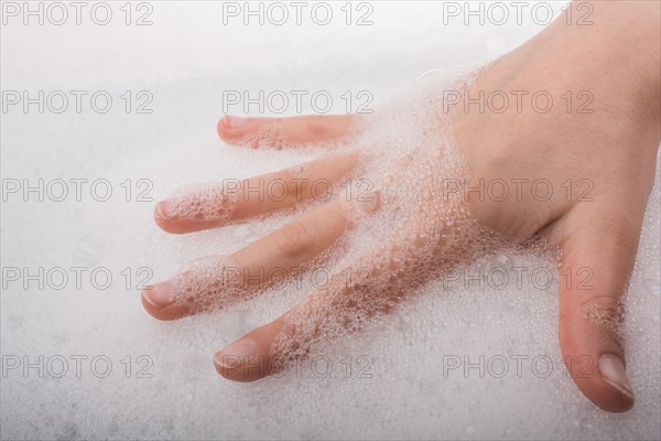 Hand washing and soap foam on a foamy background