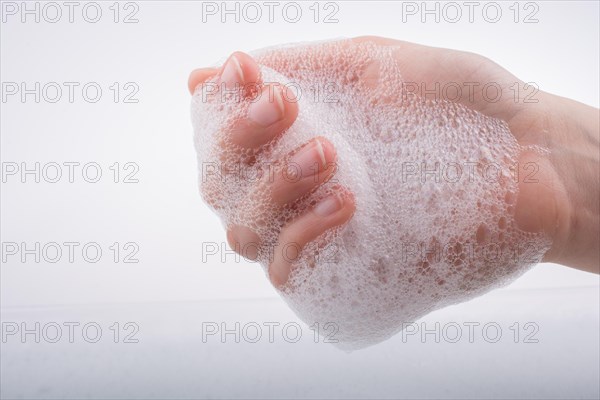 Hand washing and soap foam on a foamy background