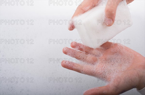 Hand washing and soap foam on a foamy background