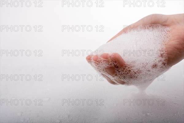 Hand washing and soap foam on a foamy background