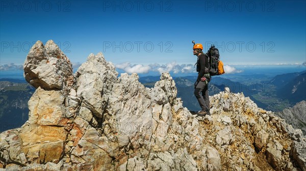 Tourist with equipment on the via ferrata trail in the alps. Zugspitze massif