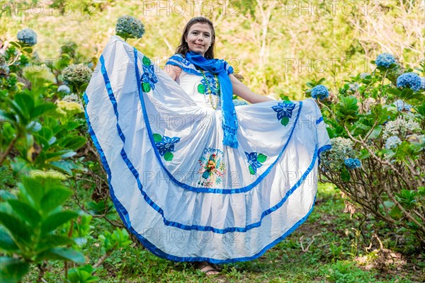 People in Nicaraguan national folk costume. Young Nicaraguan woman in traditional folk costume in a field of Milflores