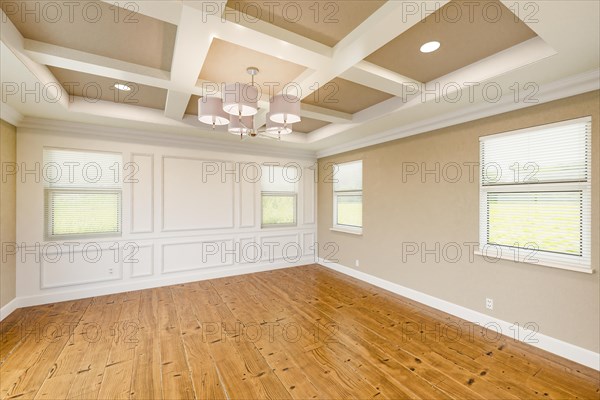 Beautiful tan custom master bedroom complete with entire wainscoting wall