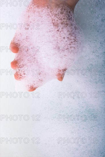 Hand washing and soap foam on a foamy background