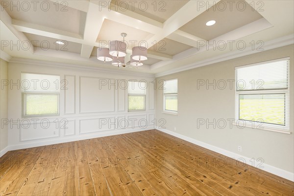 Beautiful tan custom master bedroom complete with entire wainscoting wall