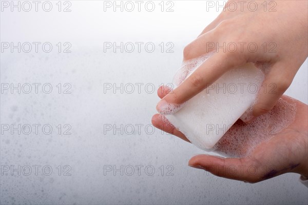 Hand washing and soap foam on a foamy background