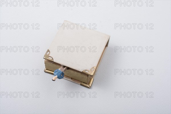 Tiny figurine of man models found beside a book
