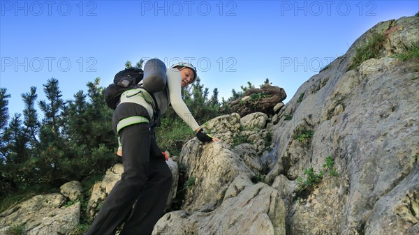 Tourist with equipment on a mountain trail in the Alps. Zugspitze massif