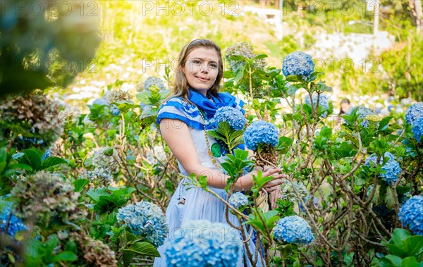 Portrait of beautiful woman in national folk costume in a field of flowers. Nicaraguan national folk costume