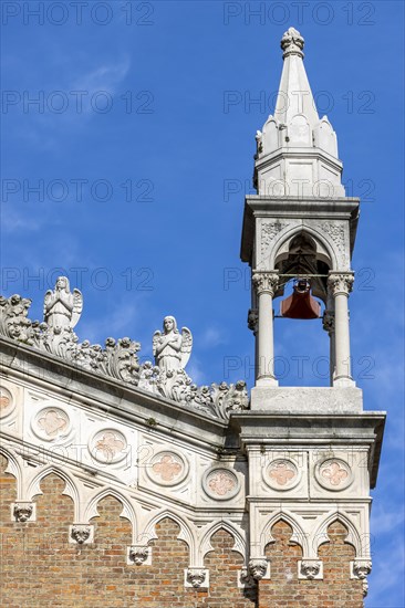 Detail of the Capuchin Church of Our Lady of Lourdes with a small tower and two small statues of angels