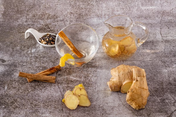 Jar of fresh ginger tea with lemon and cinnamon